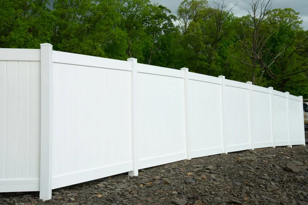 White vinyl fence fencing of private property grass plastic