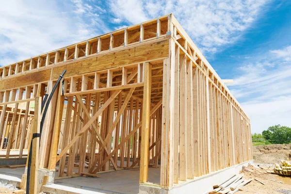 New residential construction home framing against a blue sky roofing construction wooden construction lumber plank