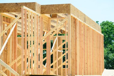 Wooden frame structure house building on a new development framing of under construction plywood plankwall
