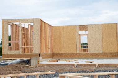 Framing of a new wooden house under construction wooden wall plywood beam residential framework work industrial