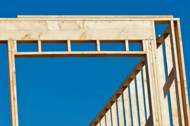 New residential construction home framing against a blue sky structure studs work wood