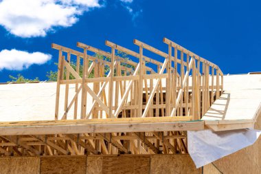 Installation of rafters on the roof of a house under construction against the background of the sky frame beam rooftop