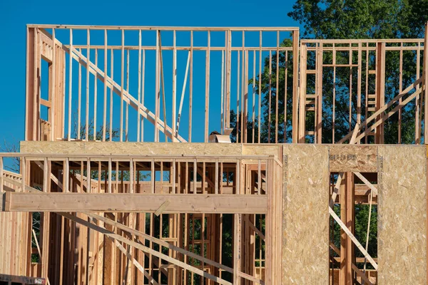 Wooden frame structure house building on a new development framing of under construction plywood plank wall framework wooden material