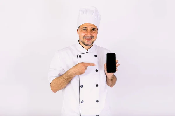 Шеф Повар Белой Шляпе Куртке Показывает Свой Мобильный Телефон Белом — стоковое фото