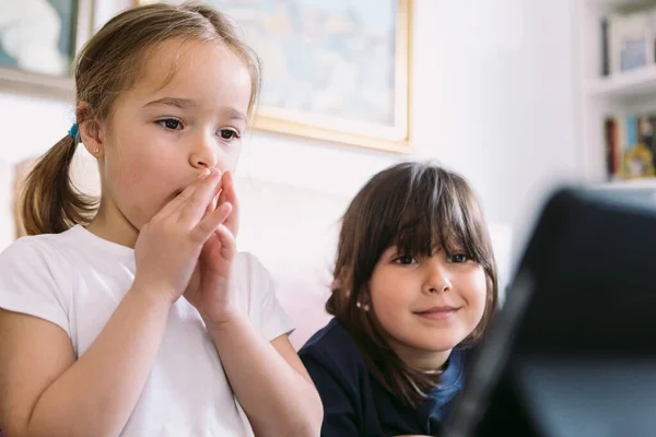 Two Little Girls Attentively Watching Video Tablet Living Room Astonished — Fotografia de Stock