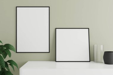 Minimalist and clean black poster or photo frame mockup on the white table leaning against the room wall with vase and plant. 3D Rendering.