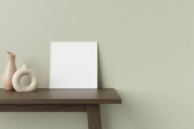 Minimalist ve temiz kare beyaz poster ya da ahşap masanın üzerinde dekoratif vazoyla duvara yaslanmış fotoğraf çerçevesi modeli. 3B Hazırlama.