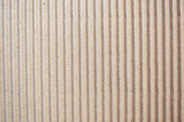 Brown color corrugated cardboard box textured background with vertical ridges