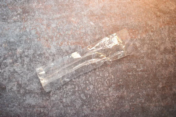 Thin transparent plastic bag on concrete background