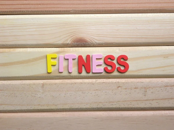 Word Fitness on wood background