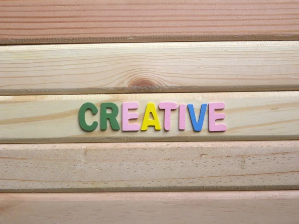 Word Creative on wood background