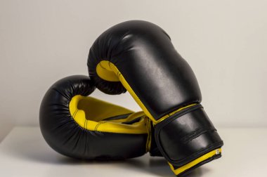 Close-Up Of Black Boxing Gloves Against White Background. Pair of black boxing gloves isolated on white background