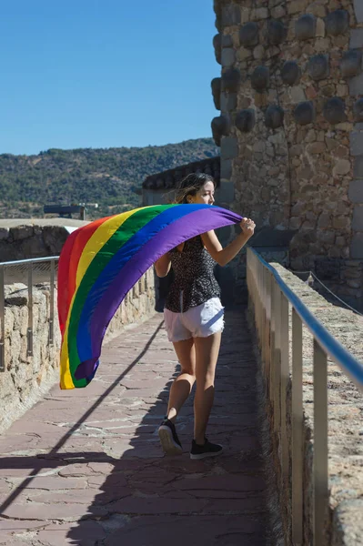 Young Woman Holding Raising Rainbow Flag Smiling Looking Side — Stockfoto