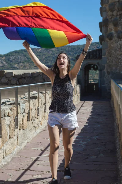 Young Woman Holding Raising Playing Rainbow Flag Wind Smiling — Stockfoto