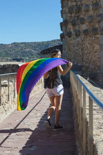 Young Woman Holding Raising Rainbow Flag Smiling Looking Side — Foto de Stock