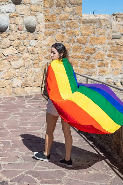 Portrait Attractive Woman Holding Rainbow Flag Her Shoulders Looking Side — Stok fotoğraf