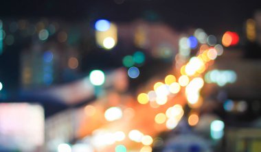 Bokeh blurred lights mounted high on the street corner abstract background.