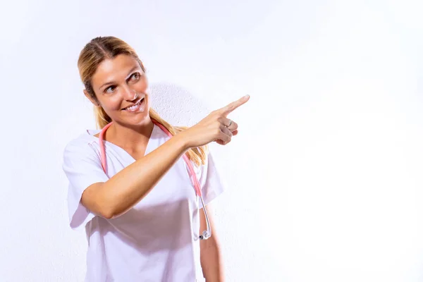 Nurse Dressed Hospital Gown Stethoscope Pointing Sanitary Concept White Textured — Stockfoto