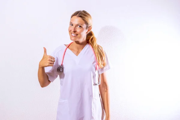 Nurse Dressed Hospital Gown Stethoscope Pointing Sanitary Concept White Textured — Stockfoto