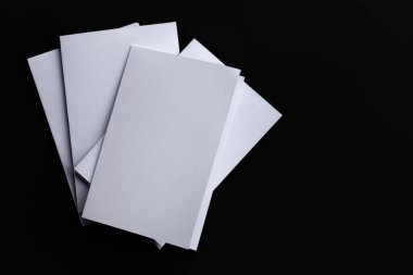 Blank Mock-up paper. brochure magazine isolated on black table, changeable background , white paper isolated on dark tone.