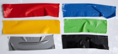 Set of yellow, green, black tapes on white background. Torn horizontal and different size sticky tape, adhesive pieces.