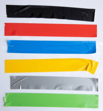 Set of yellow, green, black tapes on white background. Torn horizontal and different size sticky tape, adhesive pieces.