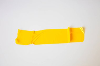 yellow tape on white background. Torn horizontal and different size yellow sticky tape, adhesive pieces.