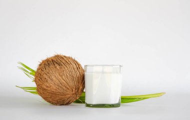 brown dry coconut and coconut milk in Ripe half cut coconut on white background.