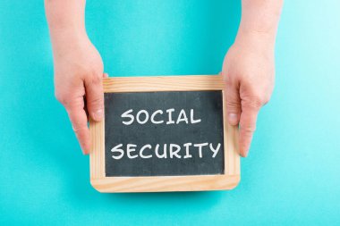 The words social security are standing on a chalkboard