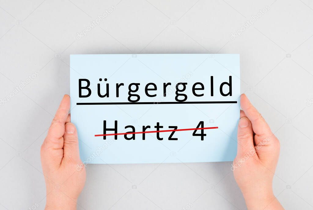 The german word for citizen money is standing on a paper, Hartz 4 is crossed out, new financial help system for unemployment in Germany, social issue
