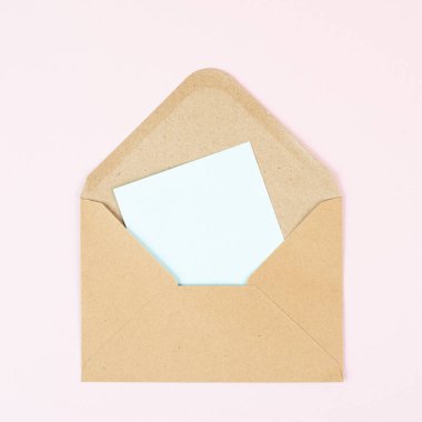 Envelope with an empty paper on a rose colored background, copy space for text, greeting card, communication and announcement concept, reminder 