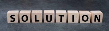 The word solution is standing on wooden cubes, solving a problem, having a business target
