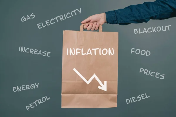 Inflation and financial crash, man holding empty shopping bag, economic development and increasing prices for food and energy