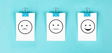Head with a sad and a happy face, mental health concept, positive and negative mindset, depression, support and evaluation symbol, emotion
