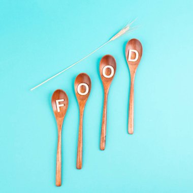 Wooden spoons with the word food and wheat ears, prices increase, crisis and shortages, supply chain problems 