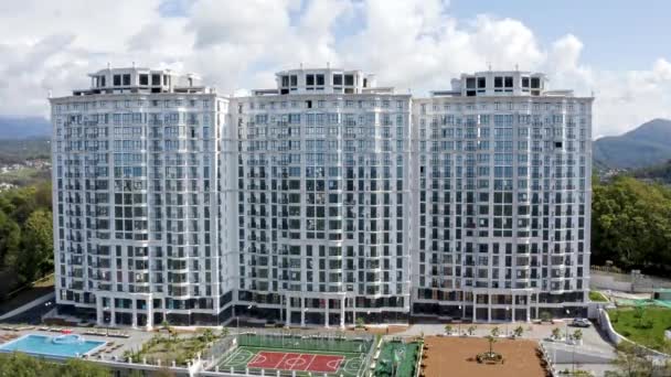 Aerial view. Construction of new multi-storey buildings in a residential area of the city of the metropolis. Building apartments. Sale and rental of real estate. Urbanization. sunny day. — Stock Video