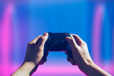 Player online oyun oynuyor oyun kumandası neon ışıklı karanlık siber punk odasında, oyun ve e-spor meydan okuma turnuva canlı ev içinde analog cihazlı flama