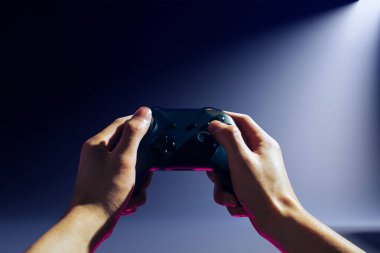 Player online oyun oynuyor oyun kumandası neon ışıklı karanlık siber punk odasında, oyun ve e-spor meydan okuma turnuva canlı ev içinde analog cihazlı flama