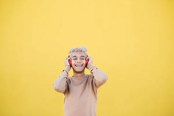 Portrait Smiling Young Man Using Red Headphones Dancing Yellow Background — Stock Photo, Image