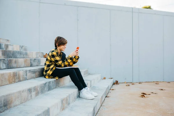 Teenager Boy Using Red Smartphone Sitting Stairs Street — Stockfoto