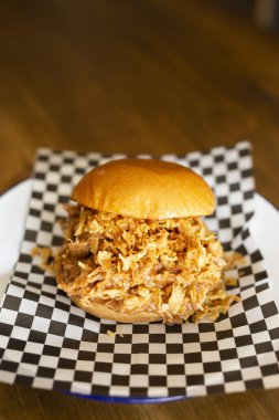 Pulled chicken burger on a wooden table