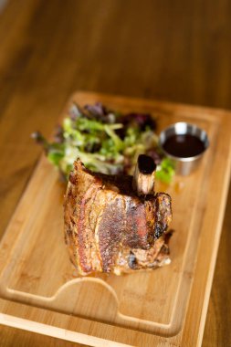 Big piece of beef rib on a wooden table 