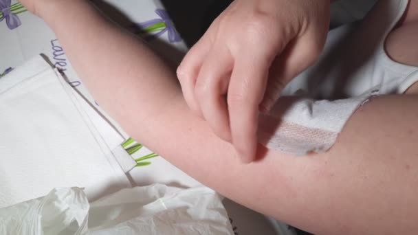 Woman Home Struggles Remove Band Aid Her Arm Top View — Stock Video