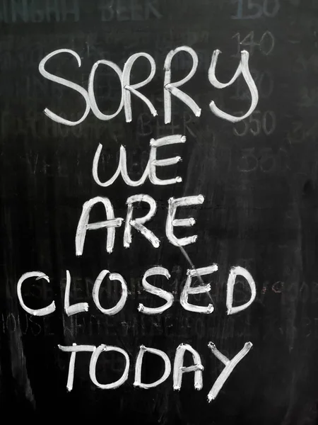 Message on blackboard in front of the shop.