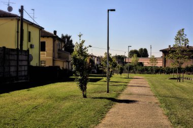 Güneşli bir günde, yerleşim yerinin parkındaki çakıl yolu.