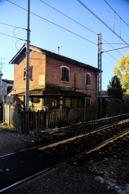 Gün batımında tren yolunun kenarındaki eski tuğla bina.