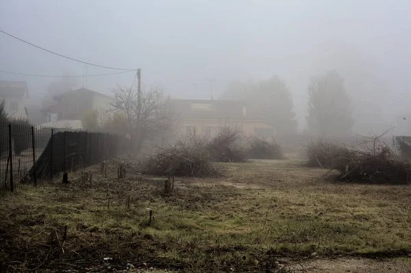 Bare Field Puddles Houses Fog Italian Countryside — стокове фото