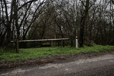 Bar by the edge of a country road in a grove on a cloudy day in winter