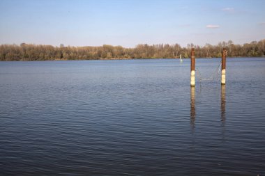 Güneşli bir günde suya yansıyan bir gölde demirlemek.