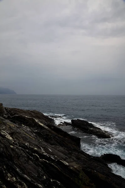 Yağmurlu ve bulutlu bir günde deniz kenarında uçurum